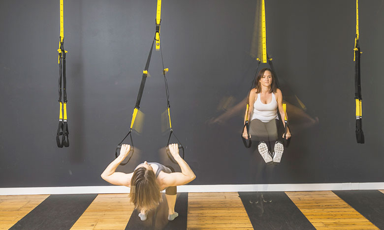 Anita and Cat from Movement Principle Pilates Brisbane in motion using TRX straps
